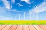 Wind Turbine On Green Rice Field Against Blue Sky Background Stock Photo