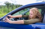 Caucasian Woman Adjusting Side Mirror Of Car Stock Photo