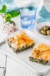 Greek Pie Spanakopita On The White Plate With Accessorizes Vertical Stock Photo