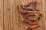 Dried Chili Pepper On Wooden Table Stock Photo