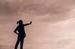 Silhouette Of Woman Praying Over Beautiful Sky Background Stock Photo