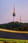 Namsangol Hannok Village And Seoul Tower Located On Namsan Mountain At Night In Seoul,south Korea Stock Photo