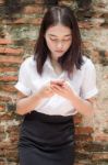 Portrait Of Thai Adult Student University Beautiful Girl Using Her Smart Phone Stock Photo