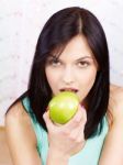 Woman Eating Green Apple Stock Photo