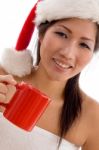 Young Woman With Christmas Hat Holding Coffee Mug Stock Photo