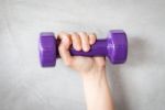 Woman Hand Holding Violet Dumbbell Stock Photo