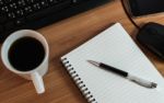 Pen On Notebook With Coffee Computer Keyboard, Mouse And Cell Ph Stock Photo