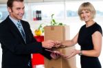 Boss Handing Over Signed Document To His Secretary Stock Photo