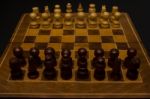 Light And Dark Wooden Chess Pieces On Chess Table Stock Photo