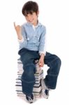 Young Boy Sitting Over Tower Of Books Stock Photo