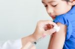 Boy And Vaccine Syringe Stock Photo