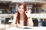 Portrait Of Thai Adult Beautiful Girl Write A Book And Smile In University Stock Photo