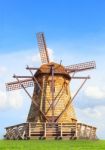 Beautiful Wind Mills On Green Grass Field Against Natural Blue S Stock Photo