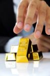 Hand Holding Gold Bars Stock Photo