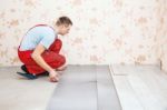 Handyman Laying Down Laminate Flooring Boards Stock Photo