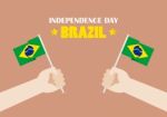 Hands Holding Up Brazil Flags Stock Photo