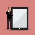 Businessman Pointing To The Screen Of A Tablet Stock Photo