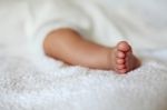 New Born Baby Foot On White Blanket Stock Photo