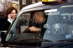 Businessman Interacting With Taxi Driver Stock Photo