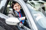 Successful Businessman Driving A Luxurious Car Stock Photo