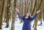 Portrait Of Young Beautiful Woman Playing With Snow In The Woods Stock Photo