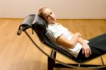 Woman Lying On Chaise Longue Stock Photo