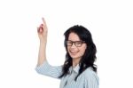 Happy Brunette In Eyeglasses Gesturing Upwards Stock Photo