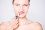 Elegant Lady Using Glossy Lipstick Stock Photo