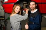 Auto Mechanic And Female Trainee In Garage Stock Photo