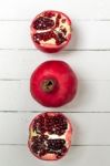 Fresh Pomegranate Fruits Isolated On A White Wooden Background Stock Photo