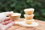 Woman's Hand Holding Mini Pies Stock Photo