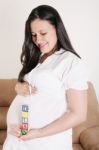 Close Up Of A Pregnant Woman With Baby Letters On Her Hand Stock Photo