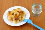 Eclairs On Plate On Wooden Table Adn Fresh Water Stock Photo