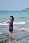 Beautiful Asian Girl Smiling At The Beach Stock Photo