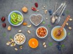 Ingredients For A Healthy Foods Background, Nuts, Honey, Berries Stock Photo