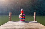 Young Girl Sitting On A Pier Stock Photo