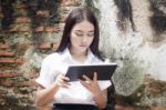 Portrait Of Thai Adult Student University Beautiful Girl Using Her Tablet Stock Photo