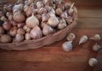 Fresh Single  Garlic Head In Basket On Wood Textured Single Garl Stock Photo