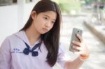 Portrait Of Thai Student Teen Beautiful Girl Using Her Smart Phone Selfie In School Stock Photo