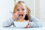 Beautiful Child Having Breakfast At Home Stock Photo