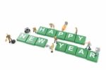 Miniature Worker Team Building Word Happy New Year On White Background Stock Photo