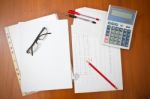 Papers On Table With Calculator Stock Photo