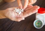 White Pills Medicine Headache On Hand Stock Photo