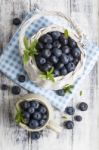 Blueberry Basket And Jug On White Wooden Table Stock Photo