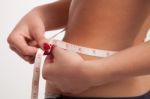 Woman Measuring Her Slim Waist With A Tape Stock Photo