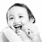 Young Cute Girl Hugging A Teddy Bear Stock Photo