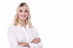 Charismatic Business Woman With Folded Arms Stock Photo