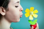 Beautiful Young Woman Blowing On Artificial Daisy Stock Photo