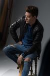 Casual Young Man In Black Leather Jacket And Denim Jeans Stock Photo