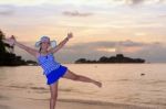 Girl On The Beach At Sunrise Over The Sea Stock Photo